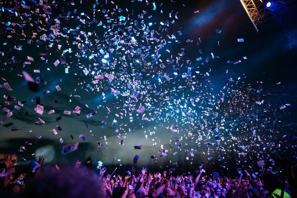 Papers thrown into the air above a crowd in celebration